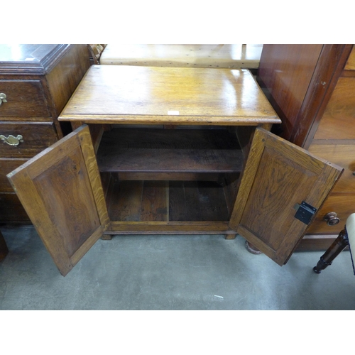 89A - An early 20th Century oak two door cupboard