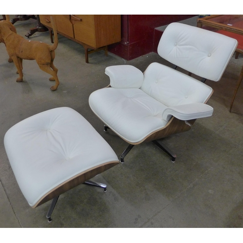 9 - A Charles & Ray Eames style simulated walnut and white leather revolving lounge chair and ottoman