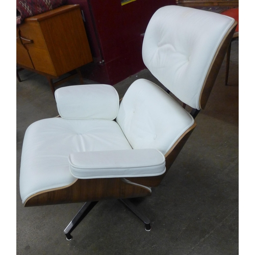 9 - A Charles & Ray Eames style simulated walnut and white leather revolving lounge chair and ottoman