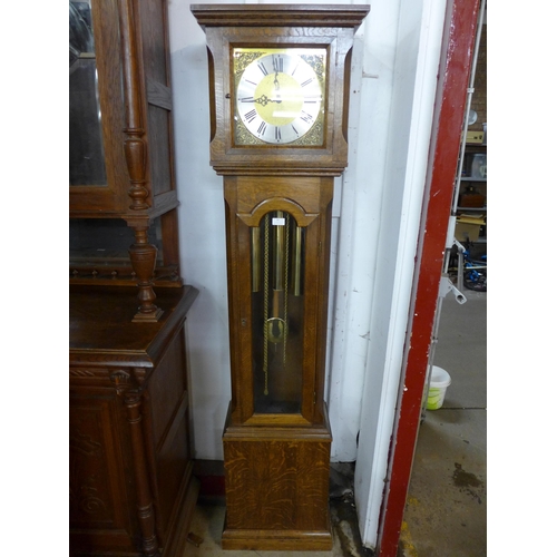 99 - An oak triple weight longcase clock