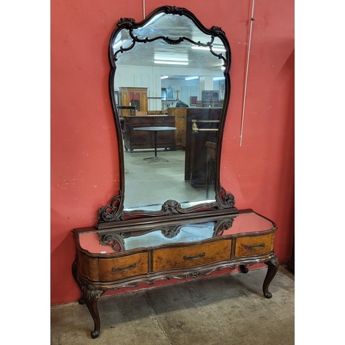 73A - An Italian Rococo style figured walnut console table and mirror