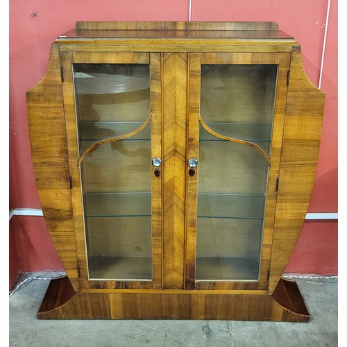 74 - An Art Deco walnut two door display cabinet