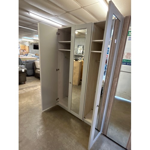 1502 - A grey painted triple wardrobe with mirrored doors * This lot is subject to VAT