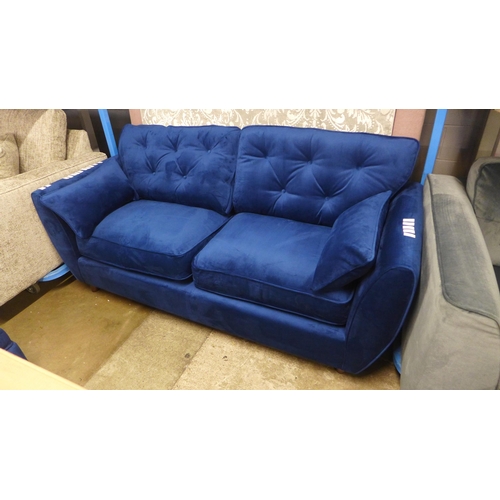 1423 - A Hoxton blue velvet upholstered three seater sofa RRP £799