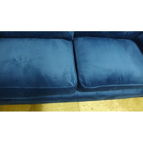 1428 - A Hoxton blue velvet upholstered three seater sofa RRP £799