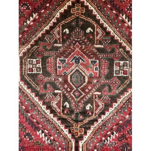 1515 - A fine hand woven, wool pile Persian Quashqai tribal carpet, 293 x 220cm