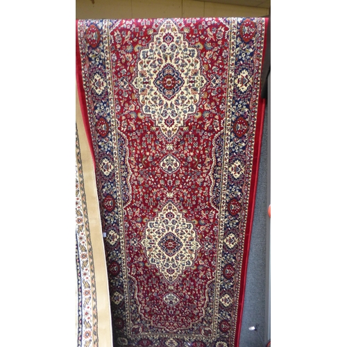 1517 - A full pile, red ground Cashmere runner, floral medallion design, 300cm x 80cm