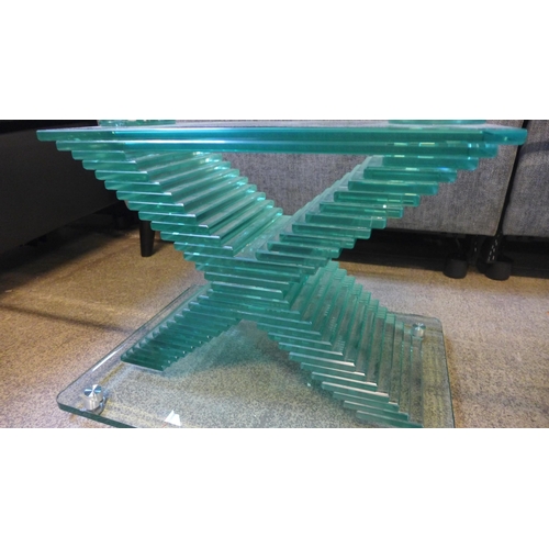 1540 - A designer heavy glass 'x' base coffee table - slightly chipped