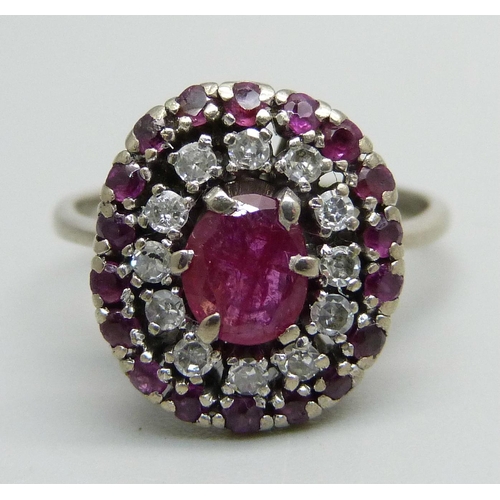 1055 - A platinum, ruby and diamond cluster ring, 4.5g, K