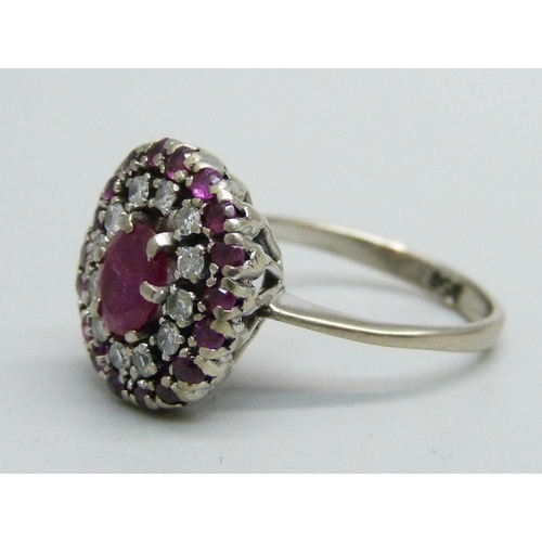 1055 - A platinum, ruby and diamond cluster ring, 4.5g, K