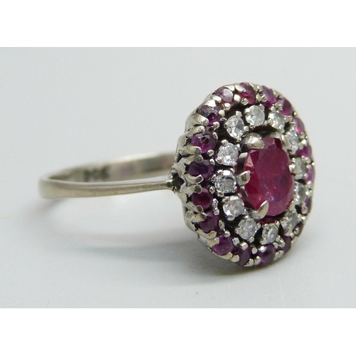 1055 - A platinum, ruby and diamond cluster ring, 4.5g, K