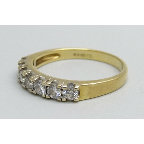 1056 - An 18ct gold, seven stone diamond ring, approximately 0.50ct diamond weight, 3.8g, Q