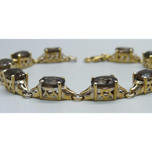 1059 - A silver gilt and smoky quartz bracelet