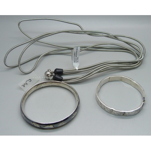 1060 - Two silver bangles, a/f, 29g, and a designer necklace