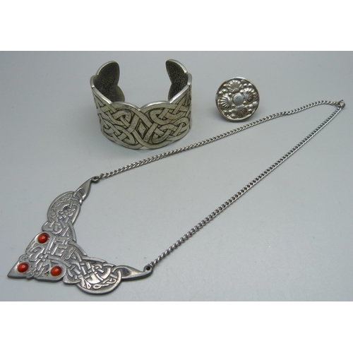 1062 - A St. Justin pewter necklace, a bangle and a ring