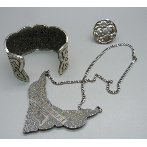 1062 - A St. Justin pewter necklace, a bangle and a ring