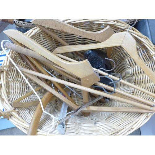 1120 - Three boxes of assorted household items, wicker laundry basket, wooden coat hangers, a 1960's baby c... 