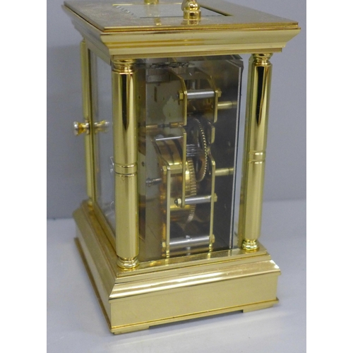 639 - A 20th Century solid brass four glass sided carriage clock, white enamel dial with Roman numerals, k... 