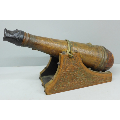 643 - A leather covered wooden decanter in the form of a cannon