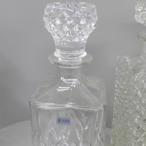 666 - A collection of crystal and glass decanters, including a boxed set of drinking glasses and Dartingto... 
