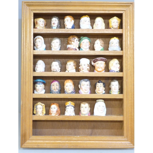 677 - A collection of 29 thimbles in the form of famous figures, all Staffordshire and signed inside, with... 