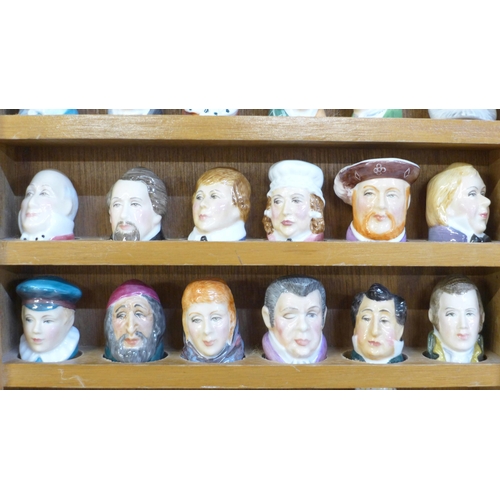 677 - A collection of 29 thimbles in the form of famous figures, all Staffordshire and signed inside, with... 