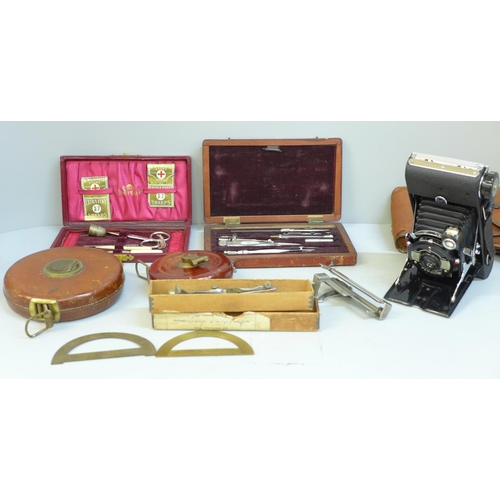 683 - A collection of measuring implements, draughtsman's tools, tape measures, etc.