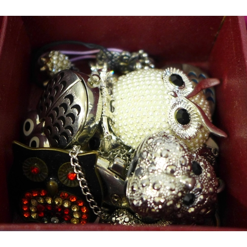 711 - A box containing 55 necklaces, a pendant, lady's wristwatches, owl brooches and a pendant watch