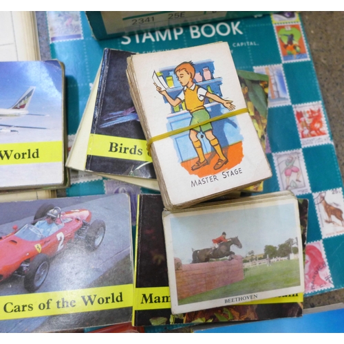 732 - A collection of stamp albums, Top Trumps, Brooke Bond Tea cards, cigarette cards, etc.