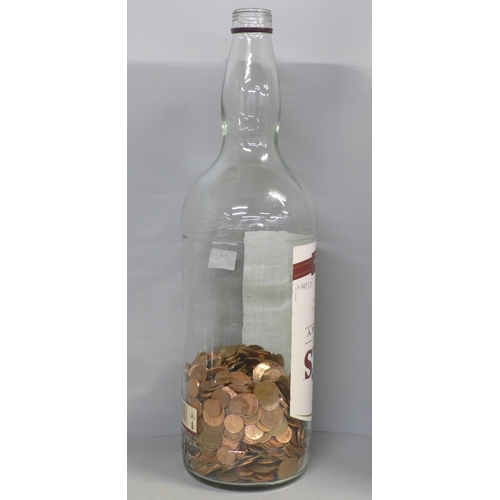 789 - A 4.5 litre Bell's Finest Old Scotch Whisky bottle, approximately 30% full with copper 1p and 2p coi... 