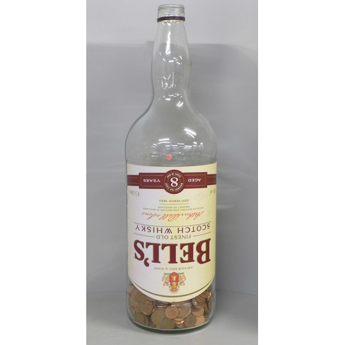 789 - A 4.5 litre Bell's Finest Old Scotch Whisky bottle, approximately 30% full with copper 1p and 2p coi... 