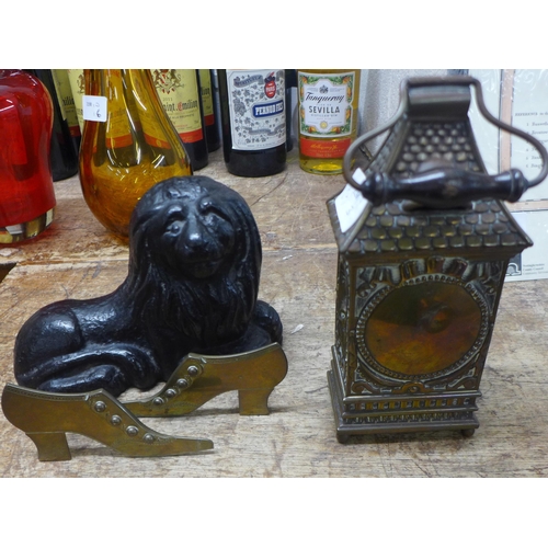 812 - A Victorian cast iron lion, brass owl lantern and a pair of brass shoes, maker E. Oakley