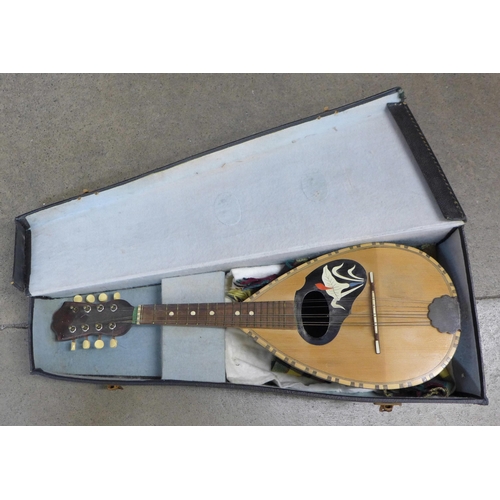 832 - A mandolin, case back split in one area, cased