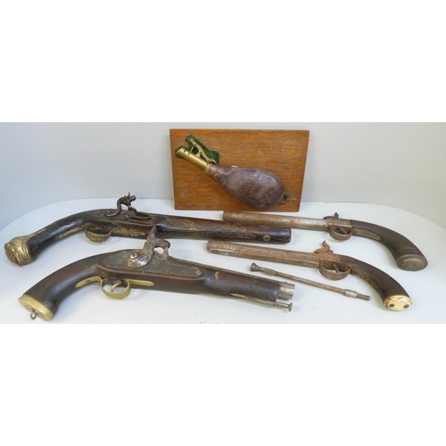 841 - Four pistols and a powder flask