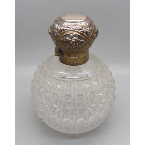 870 - A Victorian silver globular cut glass perfume bottle, London 1892, marked Mappin & Webb, 13cm, with ... 