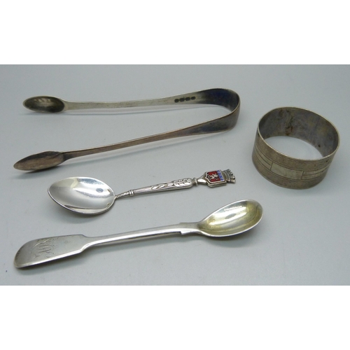 879 - A pair of silver sugar bows, a silver napkin ring, an early 19th Century silver mustard spoon and on... 