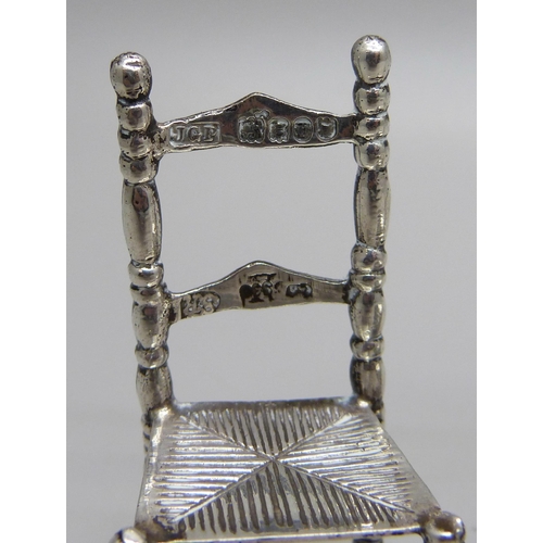 884 - Two miniature silver model chairs with London import marks, 1897 and 1902, and a smaller 925 silver ... 