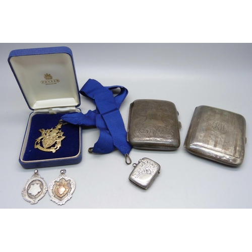 895 - Two silver cigarette cases, two silver fob medals, a silver vesta case and a silver Freeman medallio... 