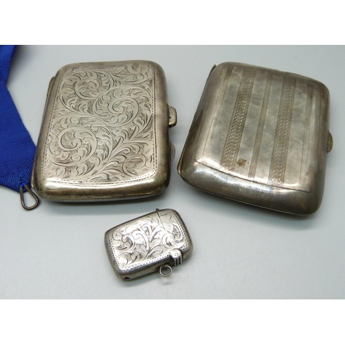 895 - Two silver cigarette cases, two silver fob medals, a silver vesta case and a silver Freeman medallio... 