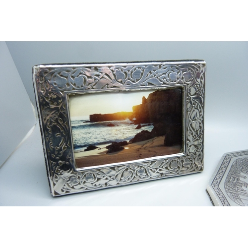 919 - A silver photograph frame, London 1985, 12cm x 16cm, and a hand mirror with engraved detail, Eastern... 