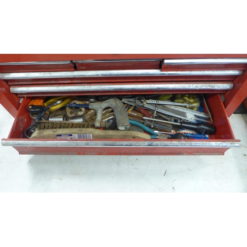 2032 - A red metal toolbox with sliding drawers including a quantity of mixed tools including sockets, scre... 