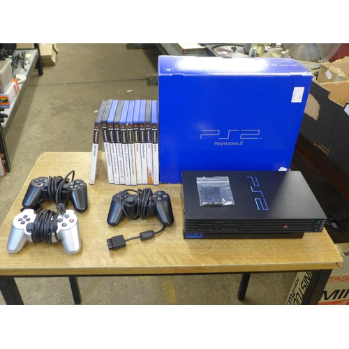 2118 - A Sony PlayStation 2 console with 3 controllers, memory card and 10 games - boxed