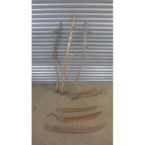 2224 - Two scythes with a scythe handle and 3 spare blades