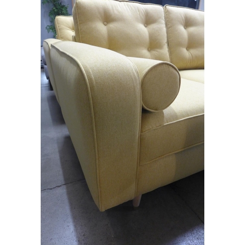 1367 - A set of mustard upholstered button backed three seater, two seater sofas and an armchair