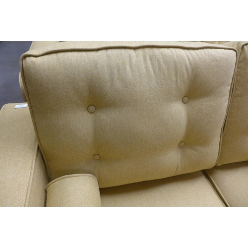 1367 - A set of mustard upholstered button backed three seater, two seater sofas and an armchair