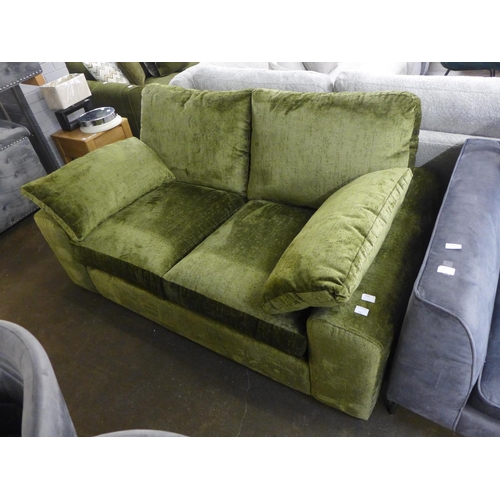 1400 - A moss green velvet upholstered three seater sofa