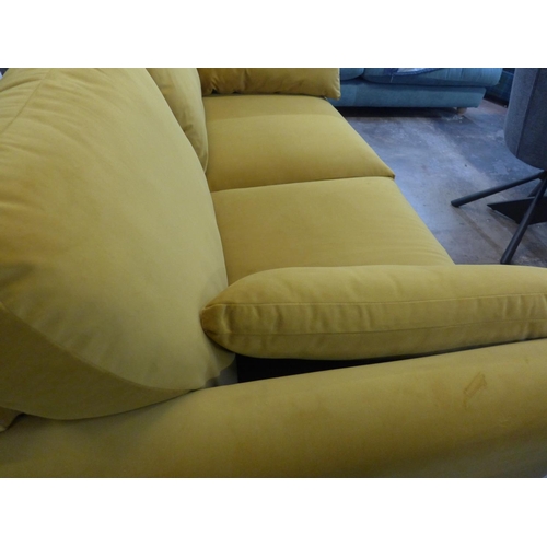 1407 - A turmeric velvet upholstered three seater sofa on dark oak legs