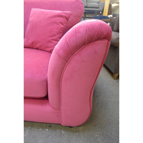 1458 - A raspberry velvet upholstered love seat with buttoned arms and zebra design scatter cushion