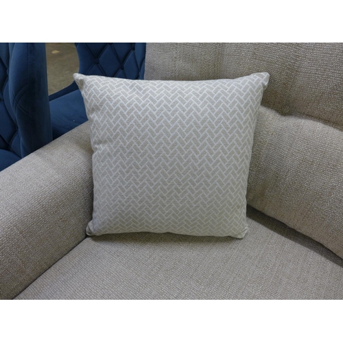 1467 - An oatmeal textured weave upholstered 2.5 seater sofa