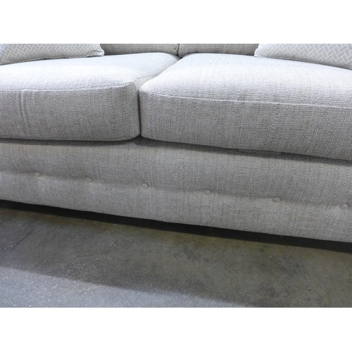 1467 - An oatmeal textured weave upholstered 2.5 seater sofa